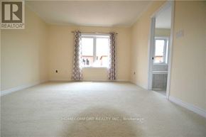 Oakville (Go Glenorchy) townhouse for rent - A room with a carpeted floor and a window with curtains.