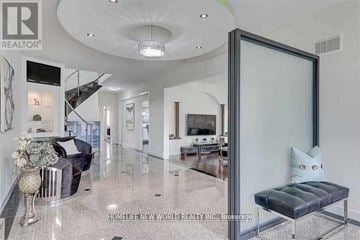 Toronto (Agincourt South-Malvern West) apartment for rent - A living room with a black couch and a glass door.
