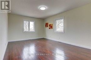 Toronto (Agincourt South-Malvern West) apartment for rent - A room with wooden floors and two windows.