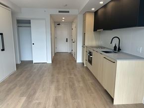 Surrey apartment for rent - A kitchen with wooden floors and white walls.