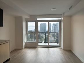 Surrey apartment for rent - A room with a large window overlooking a cityscape.