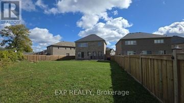 Innisfil apartment for rent - A real estate brokerage image of a residential area with houses and a fence.