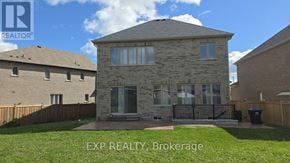 Innisfil apartment for rent - A house with a stone facade and a black gate in front.