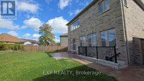 Innisfil apartment for rent - A house with a lawn and a fence in front of it.