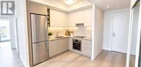 Toronto (Moss Park) condo for rent - A kitchen with a refrigerator, sink, and countertop.