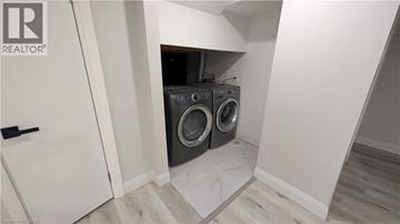 Hamilton apartment for rent - A laundry room with a washer and dryer built into the wall.