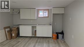 Hamilton apartment for rent - A room with a window, cabinets, and a broom.