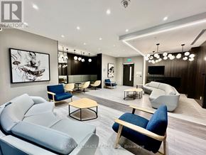 Toronto (Islington-City Centre West) condo for rent - A modern living room with a grey sofa and a wooden coffee table.