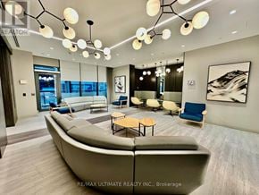 Toronto (Islington-City Centre West) condo for rent - A modern living room with a large sectional sofa and a coffee table.