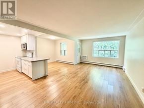 London South (South F) condo for rent - A spacious room with wooden flooring and a kitchenette.
