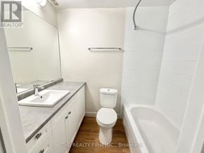 London South (South F) condo for rent - A white bathroom with a toilet, sink, and bathtub.