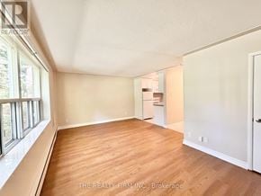 London South (South F) condo for rent - A room with wooden floors and white walls, with a window on the left side.