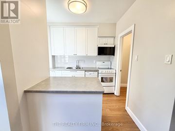 London South (South F) condo for rent - A kitchen with white cabinets and appliances is shown.