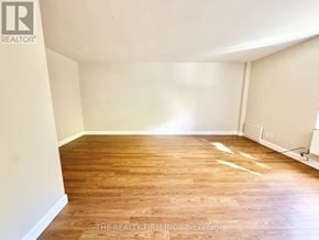 London South (South F) condo for rent - A room with wooden flooring and white walls.