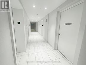 Toronto (Kensington-Chinatown) condo for rent - A long hallway with doors on both sides and a sign that says "REALTOR".