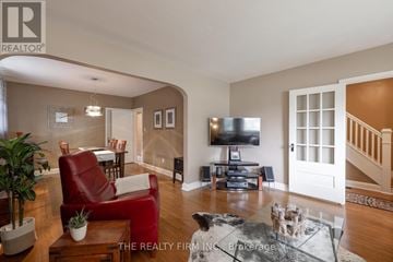 London East (East H) apartment for rent - A living room with a red chair and a glass coffee table.