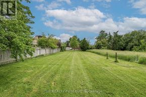 London East (East H) apartment for rent - A grassy field with a fence and trees in the distance.