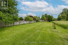 London East (East H) apartment for rent - A grassy field with a fence and trees in the distance.