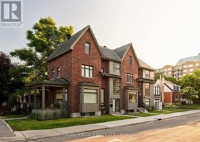 Ottawa apartment for rent - A brick house with a black roof and a white door.