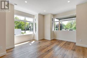 Ottawa apartment for rent - A spacious room with wooden floors and large windows.