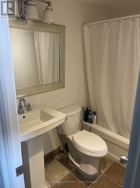 Toronto (Cabbagetown-South St. James Town) condo for rent - A white toilet in a bathroom with a sink and a mirror.