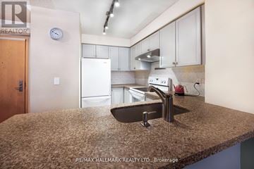 Markham (Commerce Valley) condo for rent - A kitchen with a sink and a refrigerator.