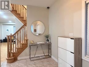 Brampton (Northwest Sandalwood Parkway) apartment for rent - A room with a staircase, a desk, and a mirror.