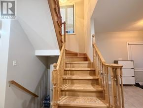 Brampton (Northwest Sandalwood Parkway) apartment for rent - A wooden staircase with a white wall on the side.