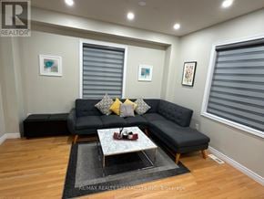 Brampton (Northwest Sandalwood Parkway) apartment for rent - A living room with a grey couch and a coffee table.