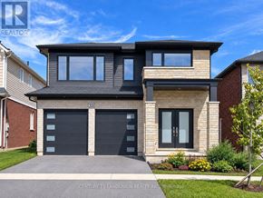 Pelham (Fonthill) apartment for rent - A modern house with a black garage door is for sale.