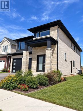 Pelham (Fonthill) apartment for rent - A modern house with a well-maintained lawn in front.