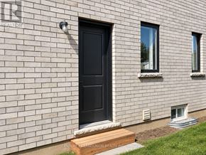 Pelham (Fonthill) apartment for rent - A house with a black door and windows with white frames.