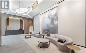 Pickering (Bay Ridges) condo for rent - A modern living room with a large grey sofa and a coffee table.
