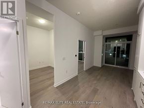 Vaughan (Vaughan Corporate Centre) condo for rent - A room with a white door and a window with a view of the city.