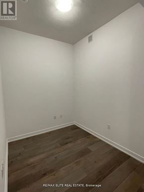 Vaughan (Vaughan Corporate Centre) condo for rent - A room with white walls and wooden flooring.