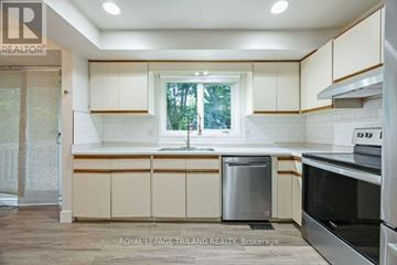 London East (East C) apartment for rent - A kitchen with white cabinets and a window.
