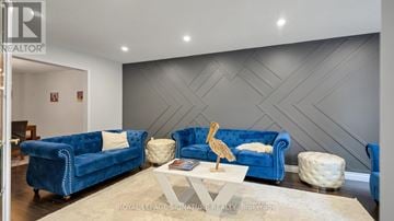 Oakville (Ga Glen Abbey) apartment for rent - A living room with a blue couch and a wooden sculpture on the coffee table.