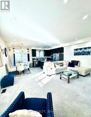 Brant (Paris) townhouse for rent - A living room with a white couch and a blue chair.