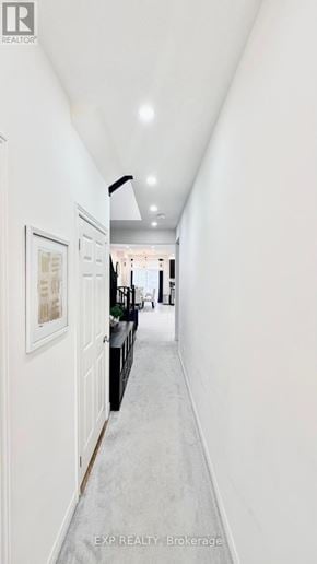Brant (Paris) townhouse for rent - A long white hallway with a black railing on the right side.