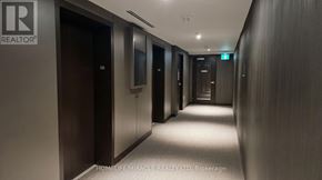 Mississauga (City Centre) condo for rent - A long hallway with doors on both sides and a sign above the door on the right.