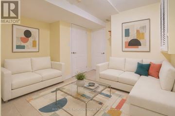 Mississauga (Lisgar) apartment for rent - A living room with white couches and a glass coffee table.