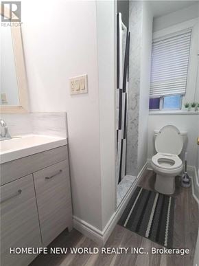 Toronto (Corso Italia-Davenport) apartment for rent - A white toilet in a bathroom with a sink and mirror.