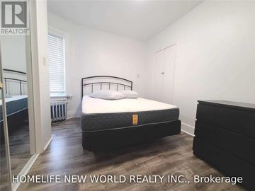 Toronto (Corso Italia-Davenport) apartment for rent - A bedroom with a large bed and a dresser.