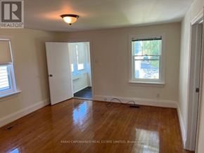 Mississauga (Lakeview) apartment for rent - A room with wooden floors and a window with a view of a street.
