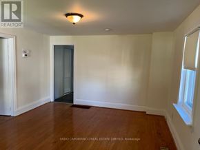 Mississauga (Lakeview) apartment for rent - A room with a wooden floor and a window on the right side.