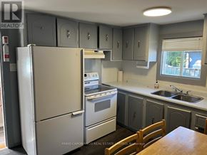 Mississauga (Lakeview) apartment for rent - A kitchen with a refrigerator, oven, sink and cabinets.