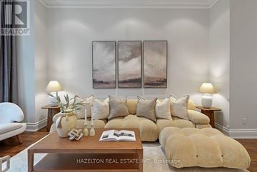 Toronto (Trinity-Bellwoods) apartment for rent - A living room with a large couch, a coffee table, and a painting on the wall.