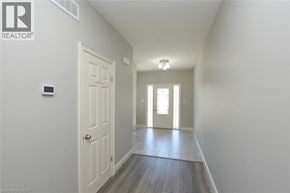 Simcoe townhouse for rent - A hallway with a white door and a light on the wall.