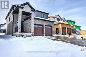 London North (North S) apartment for rent - A house with a brown garage door is in front of a house with a green garage door.