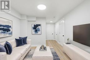 Hamilton (Mcquesten) apartment for rent - A living room with a white couch and a painting on the wall.